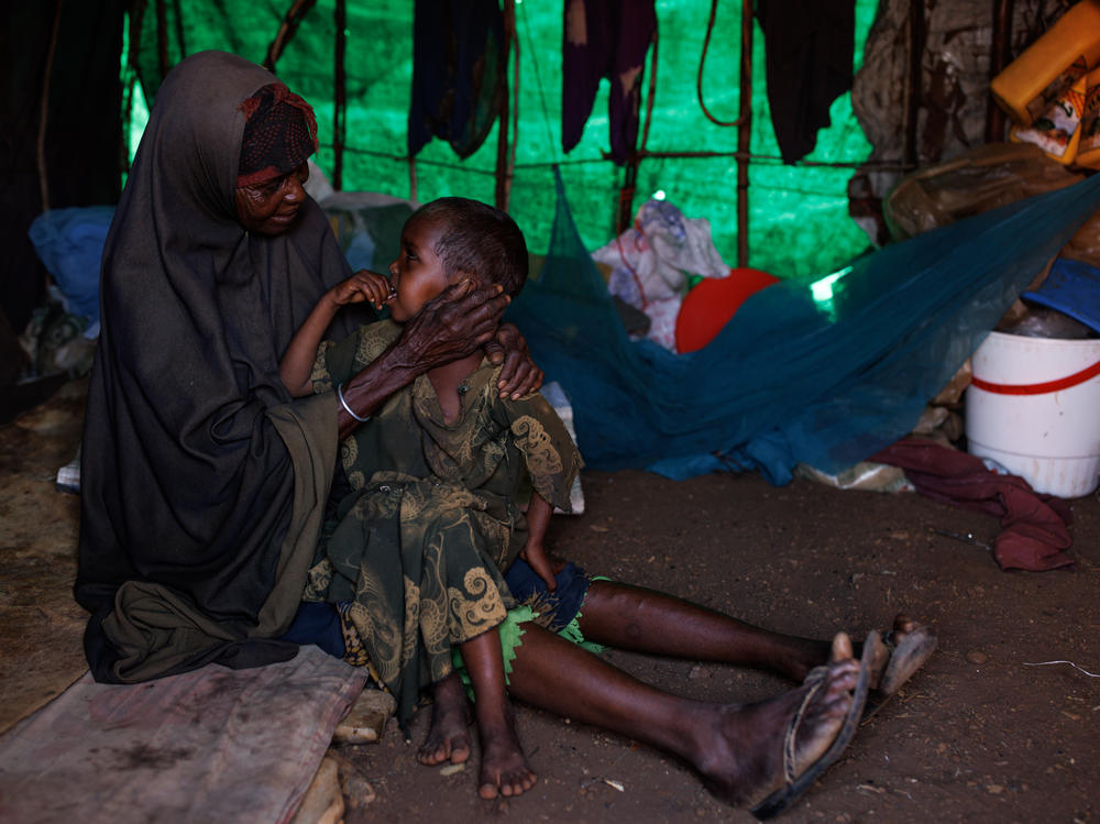 Mariam Kasim sits with her grandson, who she says is suffering from measles and malnutrition, at a camp on the outskirts of Baidoa, Somalia, on Tuesday.