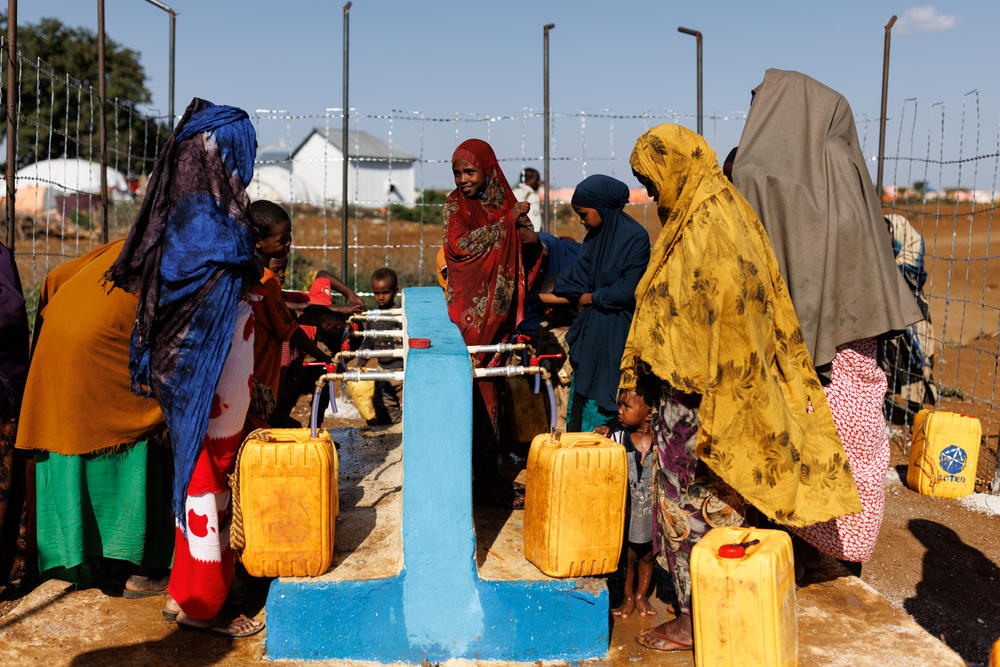 Women collect water at a displaced persons' camp in Baidoa.