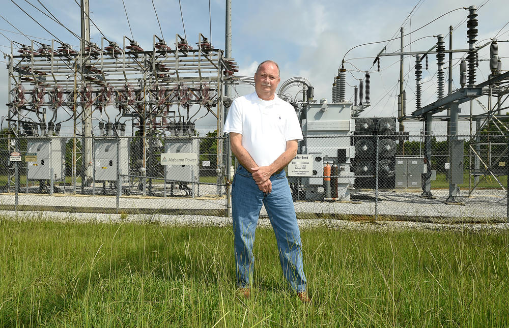 Terry Dunn, a former Alabama public service commissioner, stands in front of an Alabama Power substation.