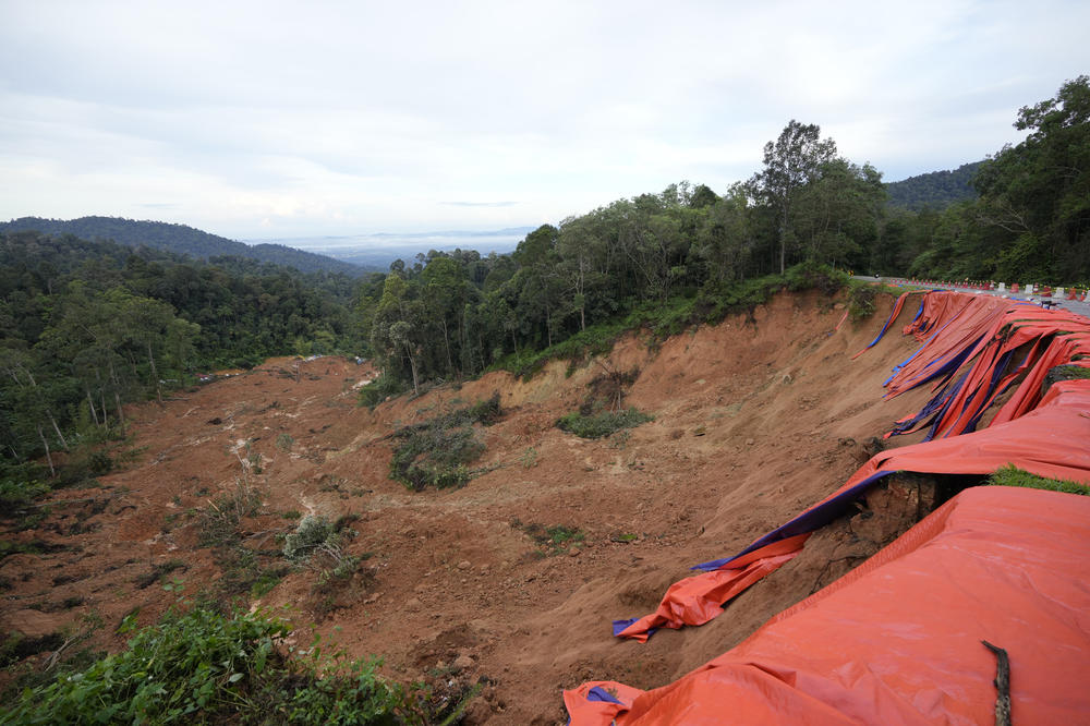 A large swath of soil is seen after Friday's landslide that covered a campground in Batang Kali, Malaysia.