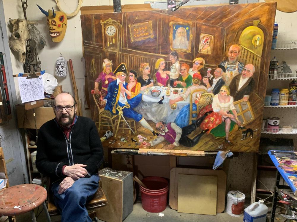 Jonah Kinigstein, 99, has been making art since he was a teenager. Some of his work satirizes modern artists such as Andy Warhol and Jackson Pollock, visible in the painting behind him.