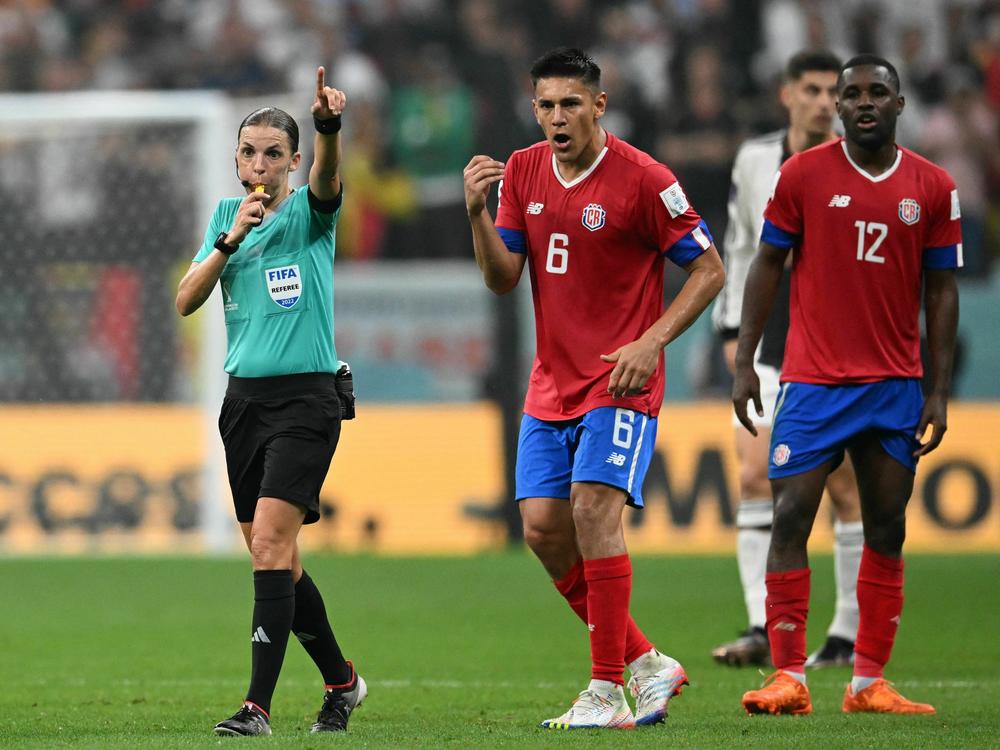 French referee Stephanie Frappart gestures next to Costa Rica's defender #06 Oscar Duarte and Costa Rica's forward #12 Joel Campbell during the Qatar World Cup match between Costa Rica and Germany on December 1, 2022.