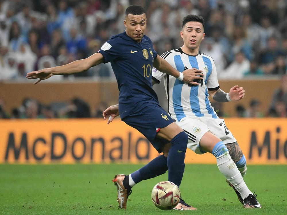 France's forward #10 Kylian Mbappe and Argentina's midfielder #24 Enzo Fernandez fight for the ball during the Qatar 2022 World Cup football final match between Argentina and France on December 18, 2022.