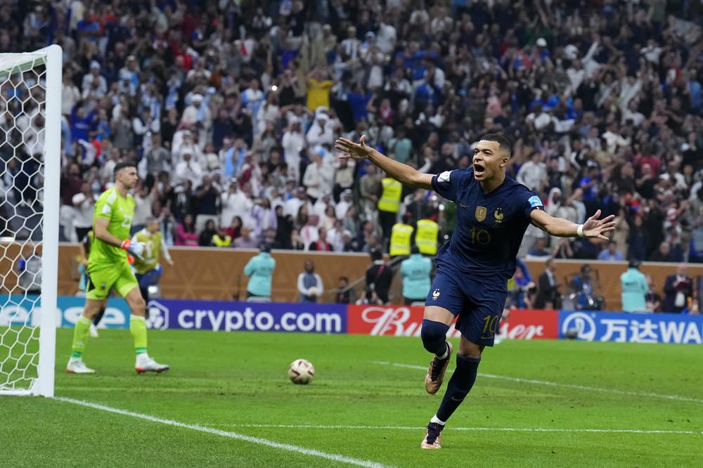 France's Kylian Mbappé celebrates scoring his side's third goal during a penalty shootout to settle the 2022 World Cup final with Argentina on Sunday, Dec. 18, at the Lusail Stadium in Lusail, Qatar.