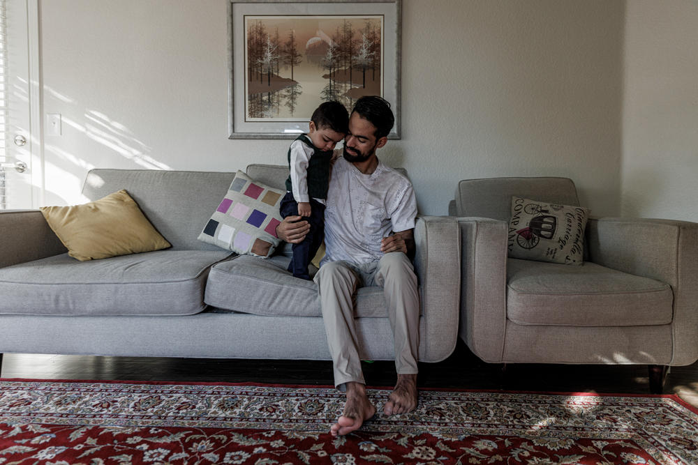 Afghan helicopter pilot Rashid Ahmad Muslim, 25, with his 14-month-old son, Mohammad, in their home in Chandler, Ariz. Mohammad was born on a U.S. military base in Germany.