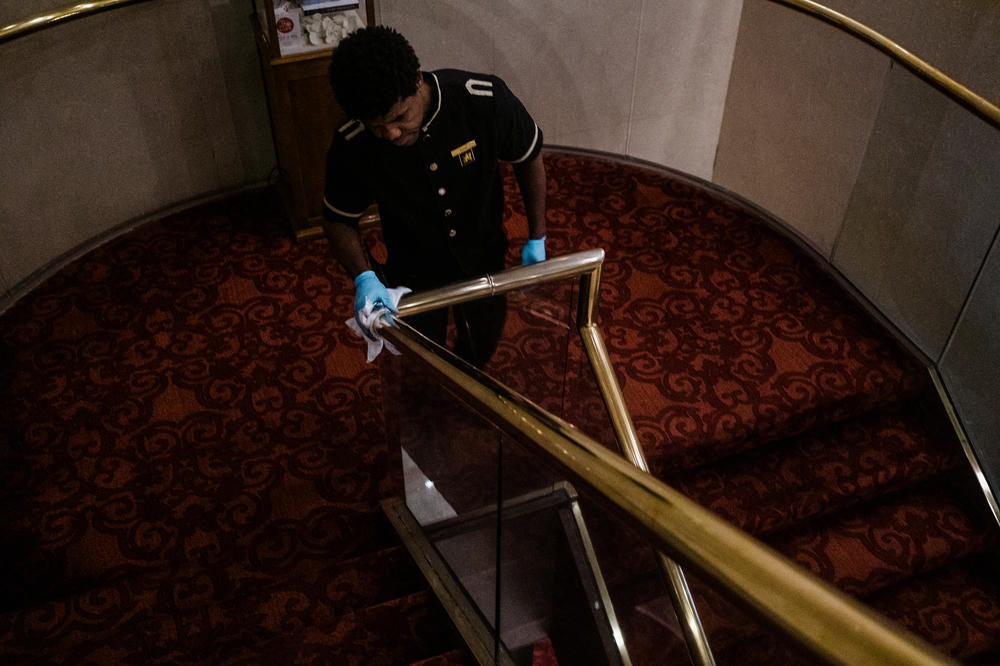 Pascal Pierre Louis demonstrates how they polish brass at the Garden City Hotel. The addition of two robot vacuums allows other staff to focus on other details.