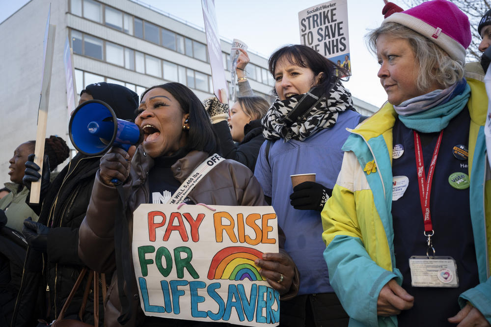 Nurses from the Royal College of Nursing strike for fairer pay and working conditions on a picket line outside St. Thomas' Hospital in London on Thursday.