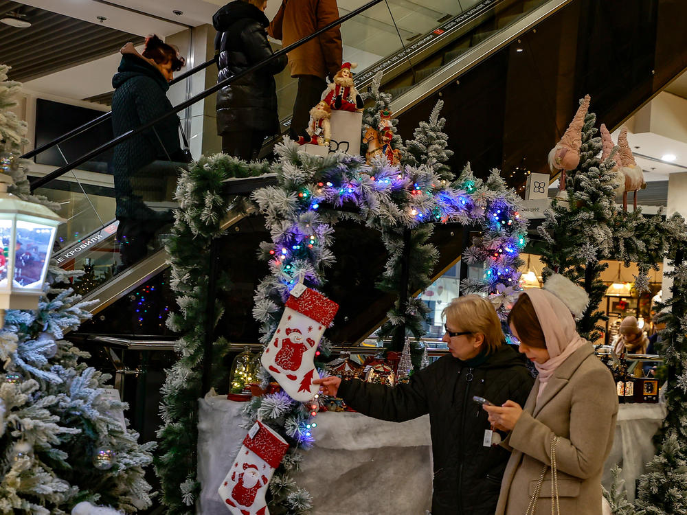 People shop in a mall decorated with winter and Christmas decorations in Kyiv, Ukraine, on Friday.