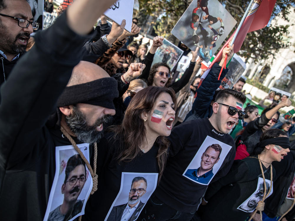 People protest against the Iranian government at a demonstration in Istanbul, Turkey, on Saturday. In recognition of those allegedly executed by the Iranian government, protesters wore nooses around their necks and held photographs of people who have been killed.