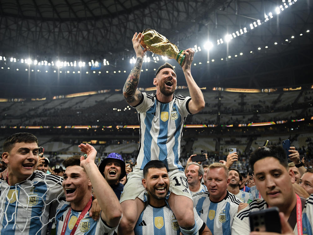 Argentina's Lionel Messi sits on Sergio 'Kun' Aguero's shoulders as their team celebrates their victory over France in the 2022 World Cup final on Sunday, Dec. 18, at the Lusail Stadium in Lusail City, Qatar.