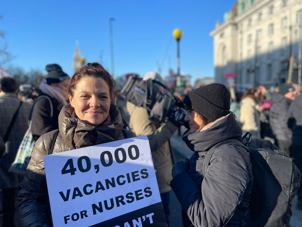 Rosie Woods, a nurse, pickets outside St. Thomas' Hospital in London on Thursday. 