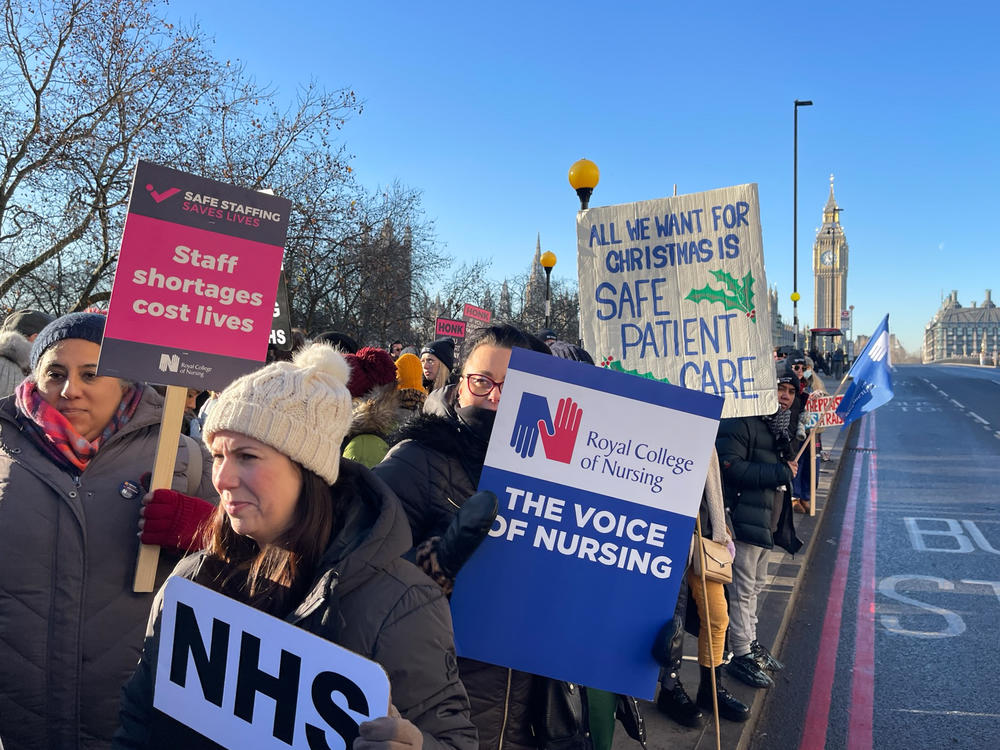 British nurses picket outside St. Thomas' Hospital in London on Thursday. The nurses' union is asking for a 19% pay raise. Nurses, as well as postal workers, rail workers and some airport immigration officers, are staging walkouts over the holiday season. They are asking for pay increases as the U.K. faces nearly 11% inflation.