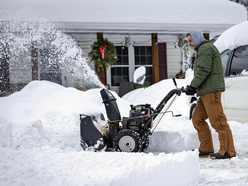 A man clears a driveway after a snow storm passed through northern Minnesota last week. Forecasters say another big storm is expected to hit the region this week.