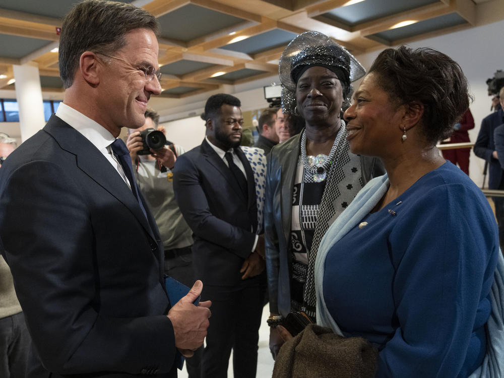 Dutch Prime Minister Mark Rutte talks to invited guests after apologizing on behalf of his government for the Netherlands' historical role in slavery and the slave trade at the National Archives in The Hague, Monday, Dec. 19, 2022.