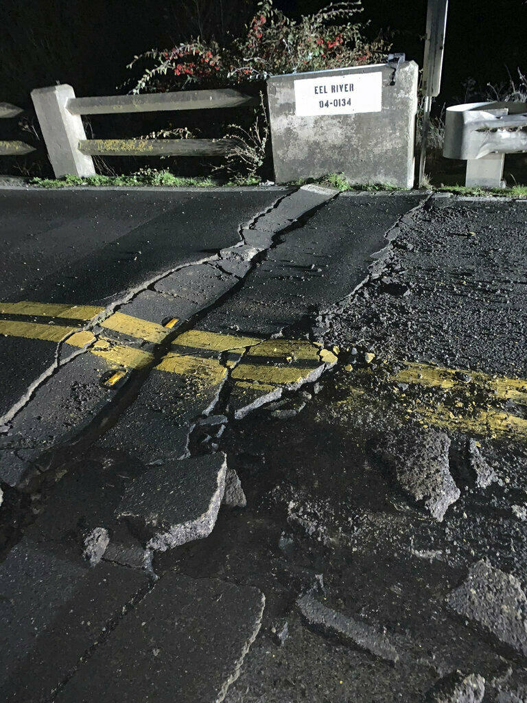 This image posted by Caltrans District 1 shows a road closure Tuesday on California State Route 211 at Fernbridge, a 1,320-foot-long concrete arch bridge that spans the Eel River near Fortuna, Calif., in Humboldt County. The bridge is closed while they conduct a safety inspection checking for possible seismic damage.