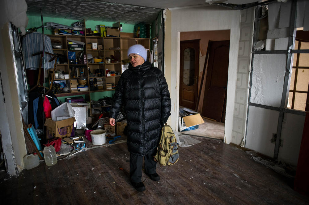 Oksana Laba visits her damaged apartment in Borodyanka, Kyiv Oblast, Ukraine, on Dec. 5. Borodyanka was occupied by Russian forces during their failed attempt to take Kyiv. Laba, who currently lives in a smaller house because she fears large apartment buildings can still be targeted by missile strikes, returned home to pick up an electric pancake- and panini-maker for her children.