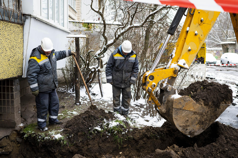 Technicians from DTEK, Ukraine's largest private energy company, work to replace a cable at a substation in the Teremky neighborhood of Kyiv on Nov. 30. Ukraine's electricians are working around the clock to maintain the country's electrical grid, which is subject to near-weekly attacks from Russian missiles and drones.