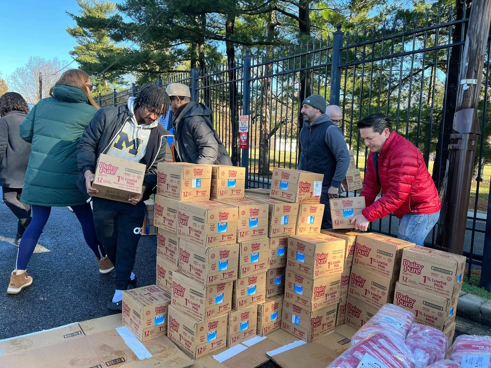 Volunteers load boxes of milk into their cars before delivering them to D.C. area schools.