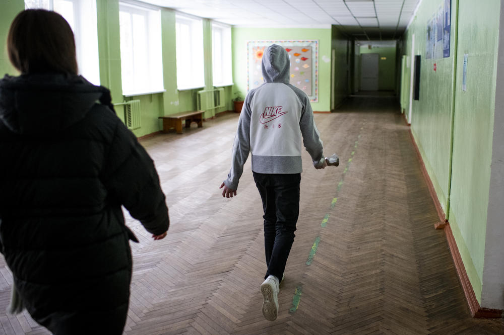 Students at a school in Bucha use a handheld bell to signal it's time for their next class on Dec. 2. The bells are necessary due to the lack of electricity.