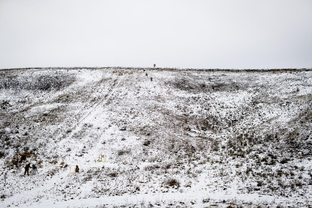 Members of Dzhokhar Dudayev Battalion train with new recruits on a hillside outside Kyiv on Dec. 3.