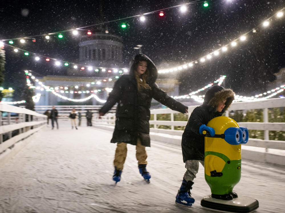 People ice skate at a Christmas market at VDNG, the Expocenter of Ukraine, in Kyiv on Dec. 3.