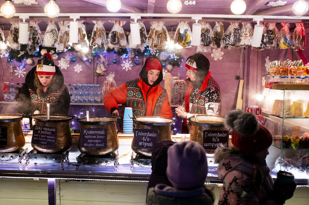 Vendors sell mulled wine at a Christmas market at VDNG, the Expocenter of Ukraine, in Kyiv on Dec. 3.