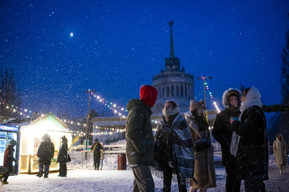 People socialize at a Christmas market at VDNG, the Expocenter of Ukraine, in Kyiv on Dec. 3.