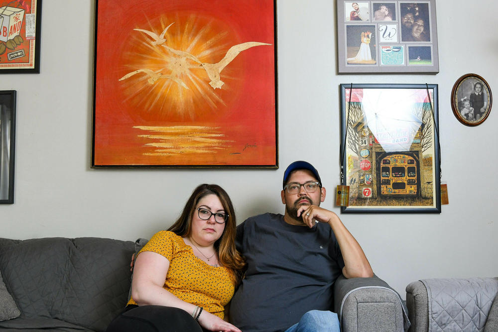 Nick and Elizabeth Woodruff pose for a portrait in their home, May, 2022, Binghamton, N.Y. The Woodruff's are approximately in $20,000 of medical debt after Nick developed an infection in his foot seven years ago that required emergency surgery.