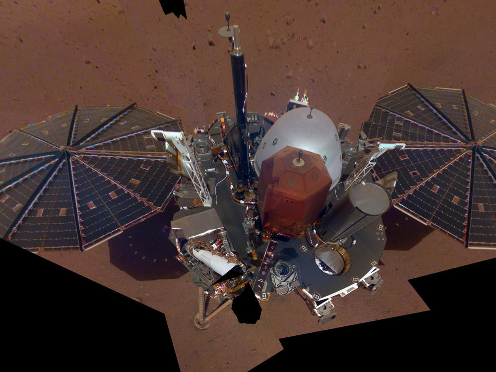 InSight took its first selfie in Dec. 2018. Its solar panels, deck, science instruments and other equipment are now covered in dust.