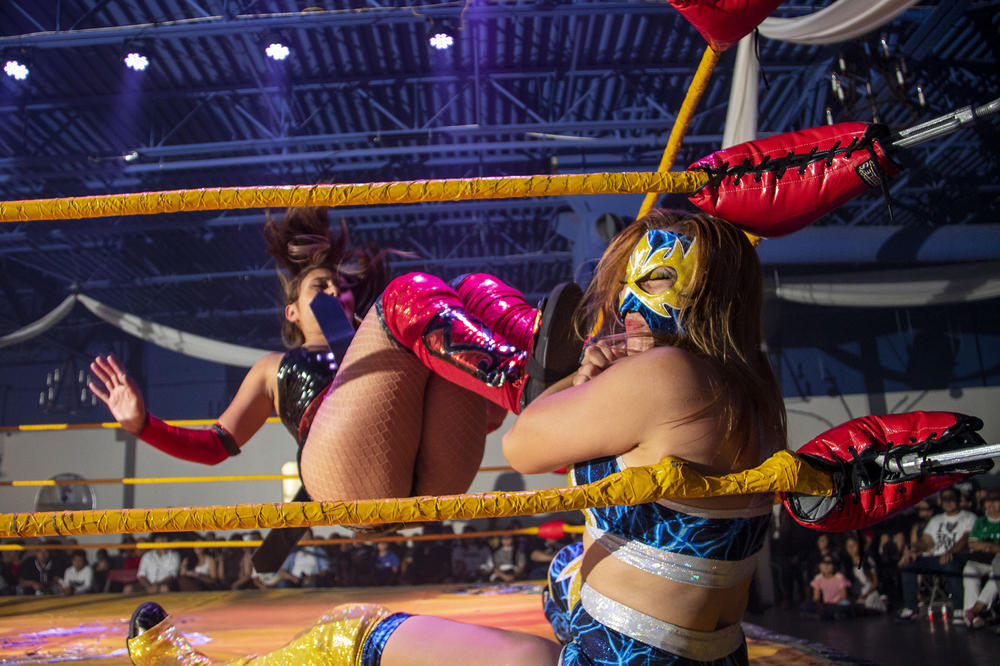 Athena Estrada drop-kicks Sakura during a lucha libra extravaganza in Aurora, Colorado. July 24, 2022.
