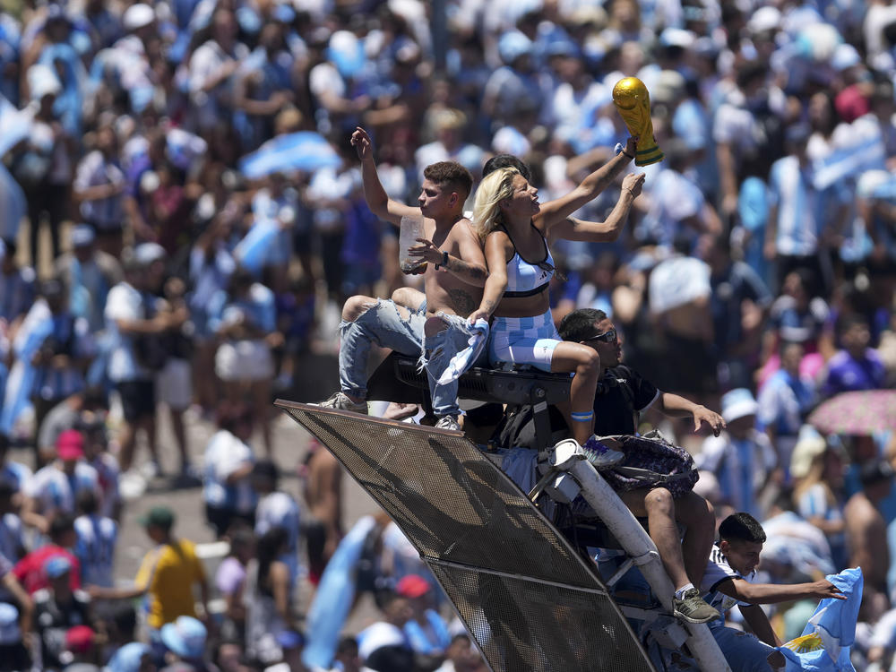 Soccer fans celebrate the Argentine soccer team after it won the World Cup title, in Buenos Aires, Argentina, Tuesday, Dec. 20, 2022.