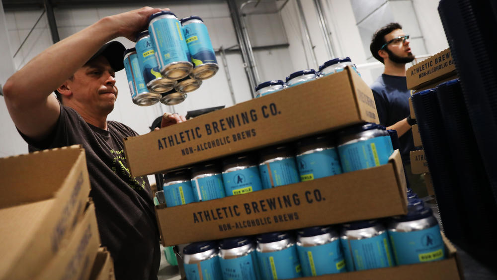 Cans of beer are packed at Athletic Brewing's nonalcoholic brewery and production plant in Stratford, Conn., in 2019.