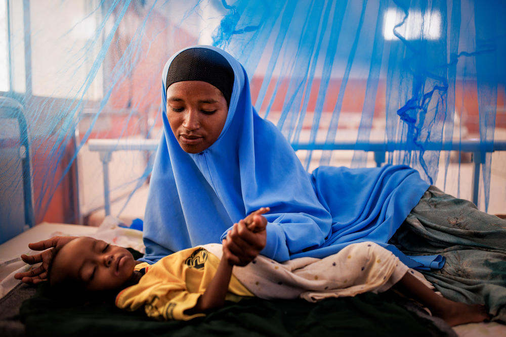 Sowda Mustaf, who is 21, caresses her 2-year-old son, Mohammed Bashir, in the intensive care ward at the Bay Regional Hospital in Baidoa, Somalia, on Dec. 14. Bashir weighs 12 pounds — about half of what a child his age should weigh.