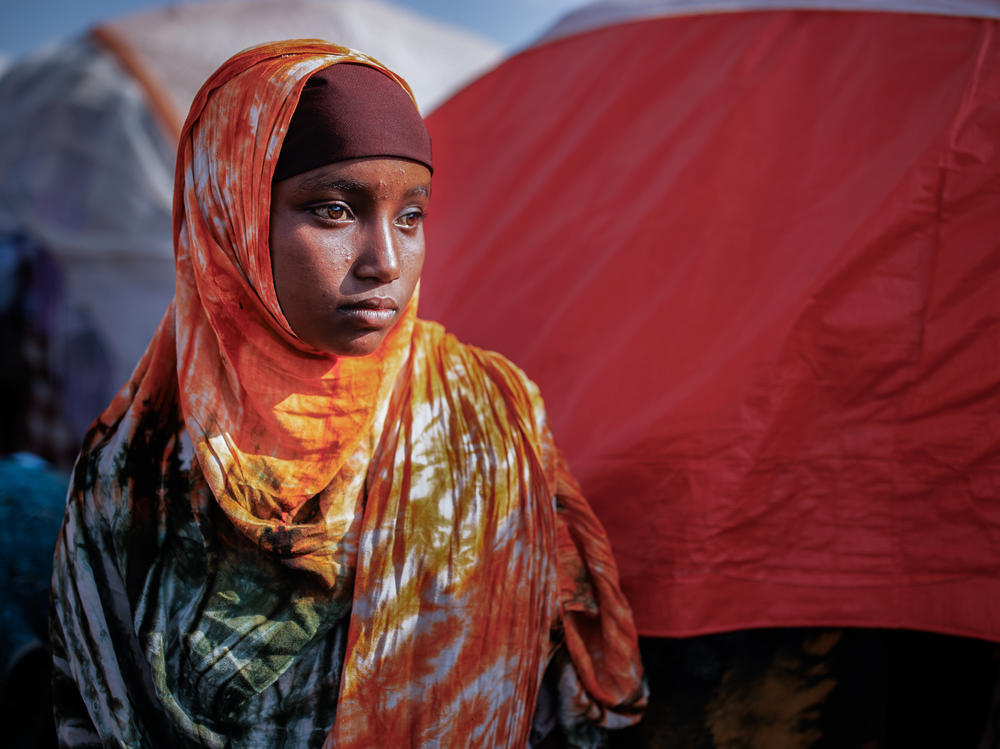 A girl poses for a portrait in a camp for internally displaced people on the outskirts of Baidoa, Somalia, on Dec. 14. As people flee their homes because of drought, famine and fighting, camps have sprung up this year around the Somali capital and other cities.