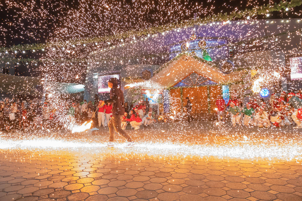 Sparks fly as a man performs a fire dance at St. Mary's Catholic Church.