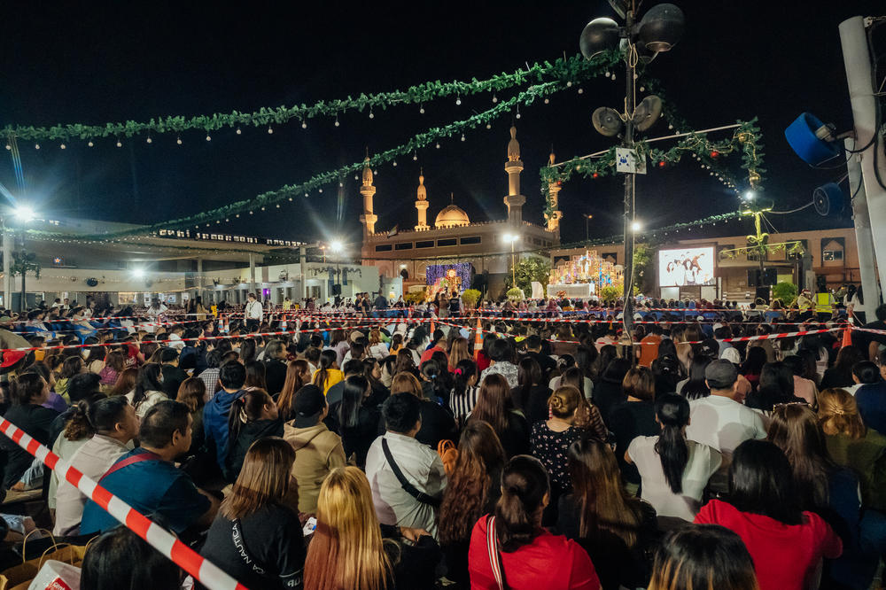 Filipinos attend Mass outside St. Mary's Catholic Church.