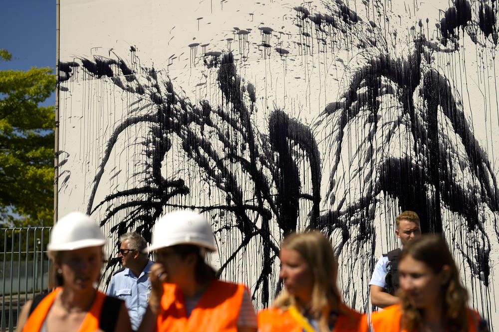 Police officers guard the chancellery after Letzte Generation activists threw black paint on it in Berlin, on June 22. The activist group claims the world has only a few years left to avoid catastrophic levels of global warming.