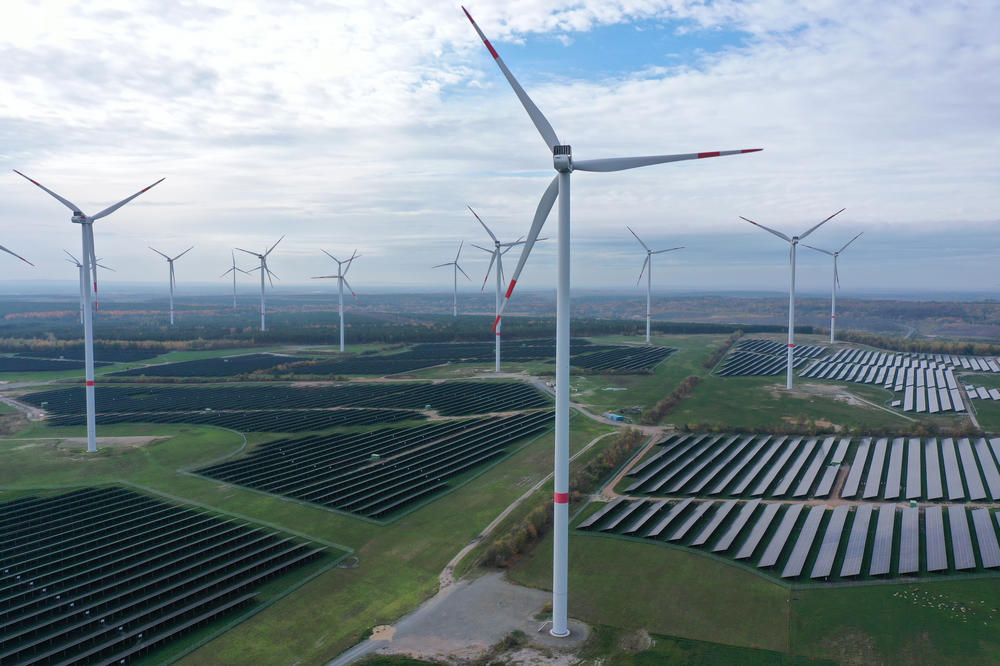 An aerial view of wind turbines producing electricity spin over a solar park on Nov. 1, near Klettwitz, Germany. The German government is seeking an accelerated transition to renewable energy sources in order to both meet its climate goals and to reduce its import needs of fossil fuels.