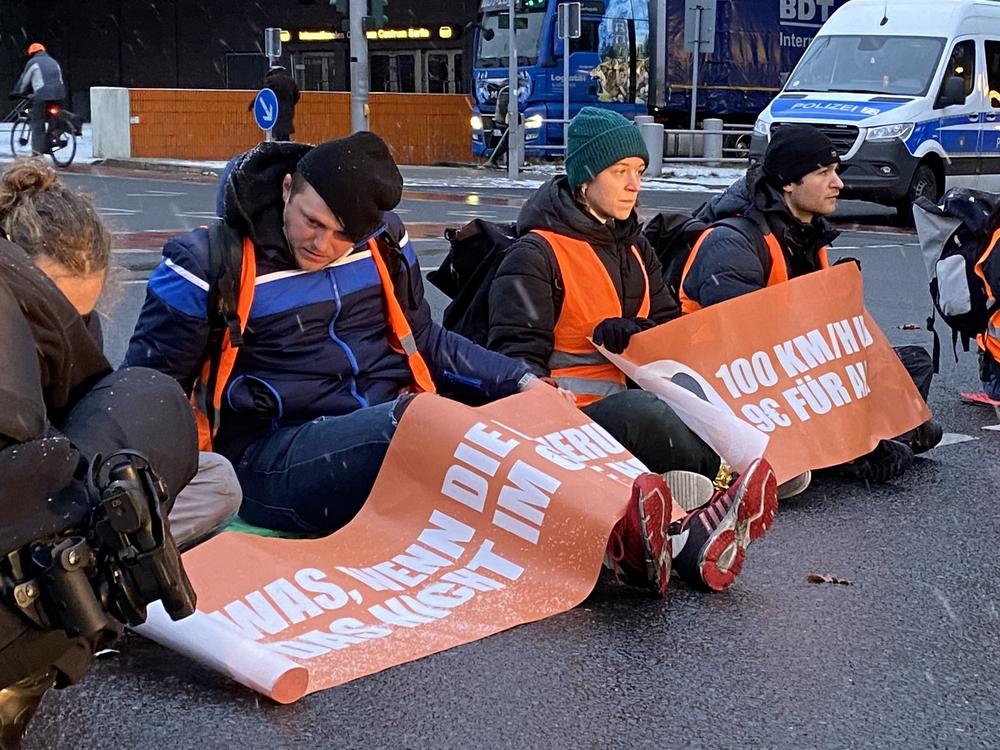 Climate activists from the group Letzte Generation (Last Generation) hold up commuter traffic on a Monday morning in Berlin by supergluing themselves to the road. Police unstick their hands using cooking oil and a pastry brush while irate drivers look on, stuck for more than an hour.