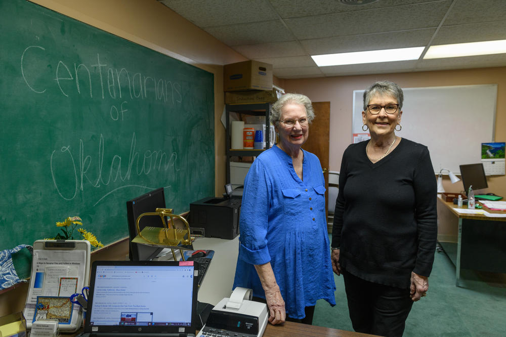 Gloria Helmuth (left) and Sue Scott from the Centenarians of Oklahoma pose for a portrait on Dec. 21 in their Tulsa office. Since its<strong> </strong>founding in 1991, the group says it has honored more than 2,700 centenarians and counting.