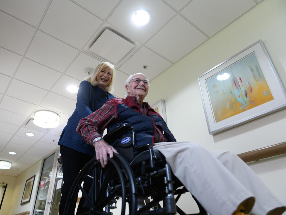 Paula Naylor pushes her father, Paul Romanello, with his wheelchair on Dec. 21 in Tulsa, Okla. Romanello was recently celebrated by the Centenarians of Oklahoma when he turned 100 years old.