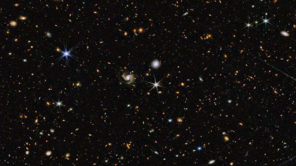 Hundreds of galaxies appear in this image, which combines near-infrared colors captured by Webb's telescope with those from Hubble.