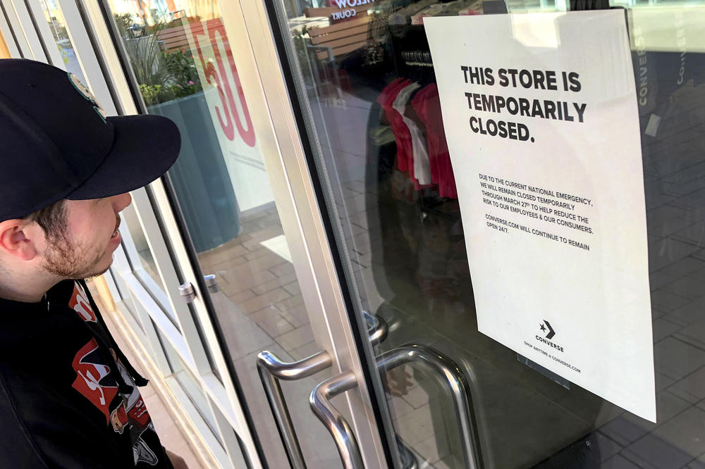 During the COVID shutdowns in March 2020, an employee visits a closed Converse shoe store in Phoenix.
