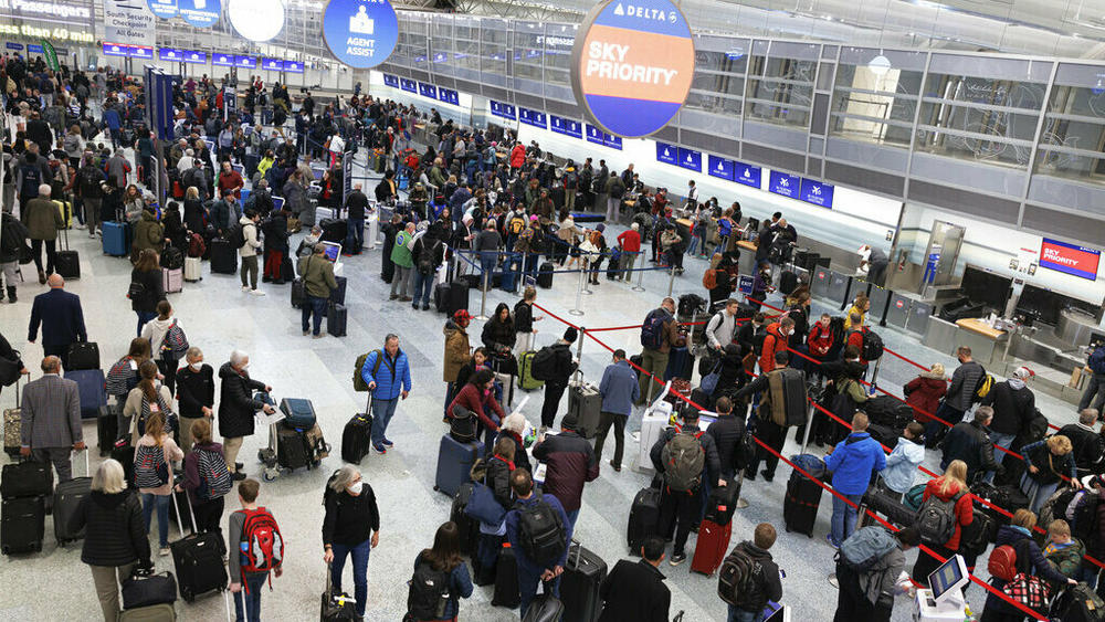 Travelers wait in line to check-in for their flights Thursday at Terminal 1 ahead of the Christmas Holiday at MSP Airport in Bloomington, Minn.