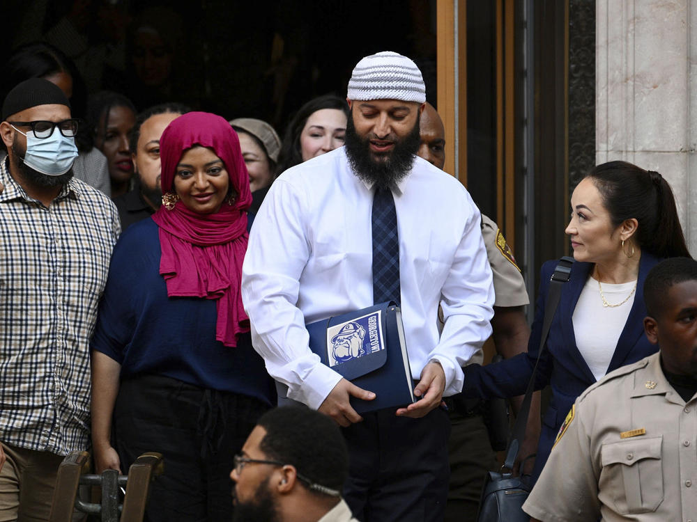 Adnan Syed (center right) leaves the courthouse after a hearing on Sept. 19, 2022, in Baltimore. Syed, who was released from a Maryland prison this year after his case was the focus of the true-crime podcast 