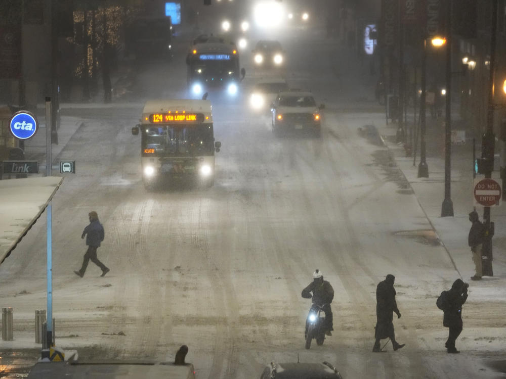 Pedestrians navigate slippery streets Thursday in Chicago's famed Loop. A massive winter storm will be hovering over the majority of the country for a few days featuring strong sub-zero wind chills and major snow accumulation.