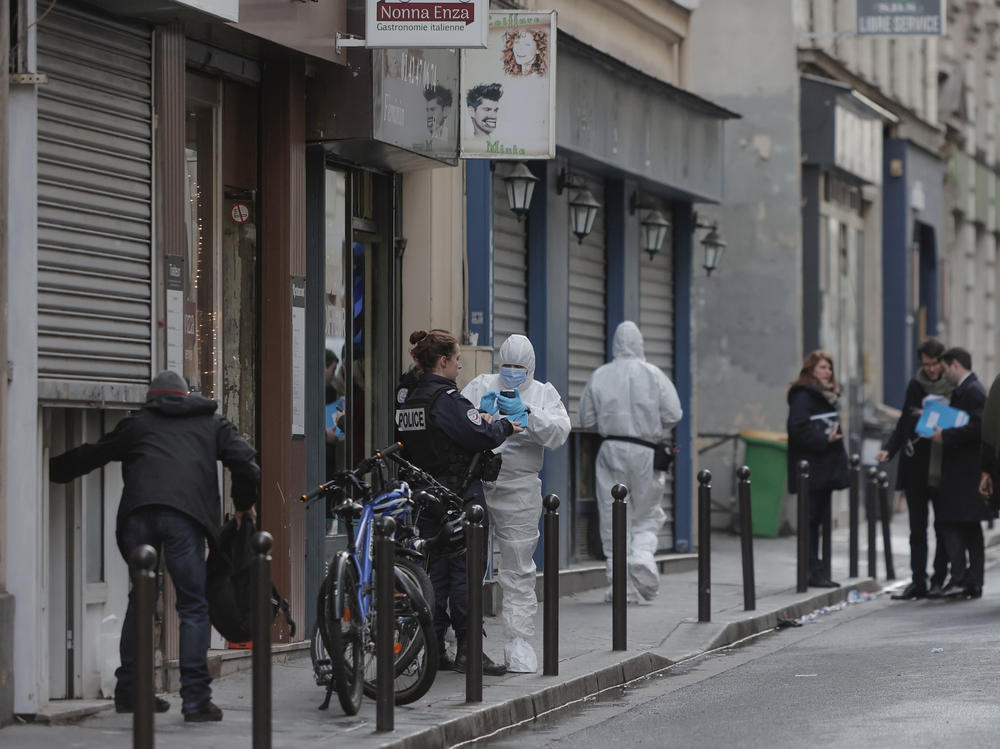 Police in Paris investigate at the scene of a shooting on Friday that left three people dead and three others wounded. A 69-year-old suspect was wounded and arrested.
