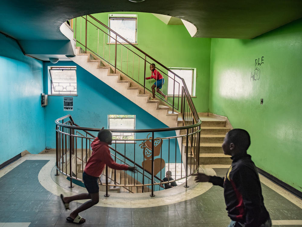 Boys play in a stairwell in Cissie Gool House, an abandoned hospital now home to over 1,000 people. By painting, decorating and maintaining the building, its new residents have managed to turn it into a decent home for themselves and their families within striking distance of central Cape Town.