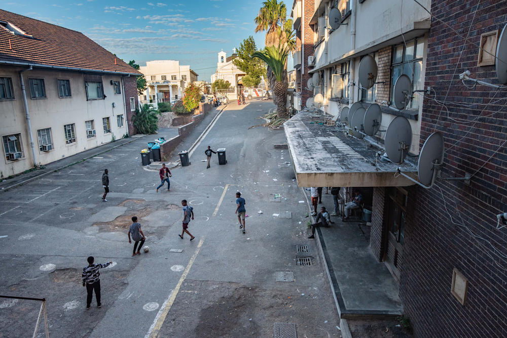 Boys play soccer in the parking lot of Cissie Gool House, where occupants have been living for almost six years.