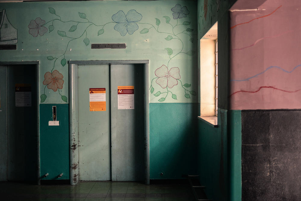 Murals and bright colors adorn the walls of a former elevator lobby in Cissie Gool House, an abandoned hospital that now houses over 1,000 people in the Woodstock neighborhood of Cape Town.